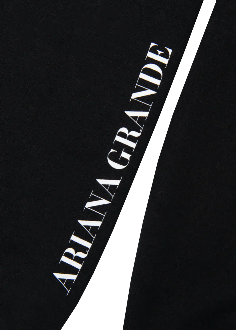 Sleeve detail of the My Everything Ariana Grande crewneck with vertical white text that reads “ARIANA GRANDE” on a solid black background.

