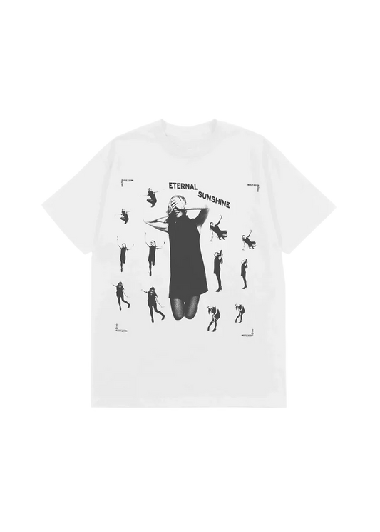 White Ariana Grande t-shirt featuring a collage of black-and-white silhouettes of Ariana in various poses surrounding a central image of her with hands over her eyes. "ETERNAL SUNSHINE" arches across the chest, capturing the ethereal vibe of the album’s visual theme.

